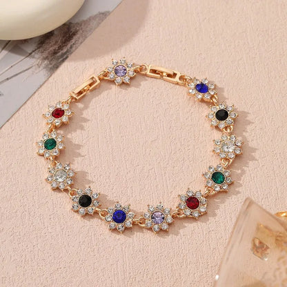 Floral shaped zinc alloy bracelet with electroplated colourful gem finishes in gold and silver tones.