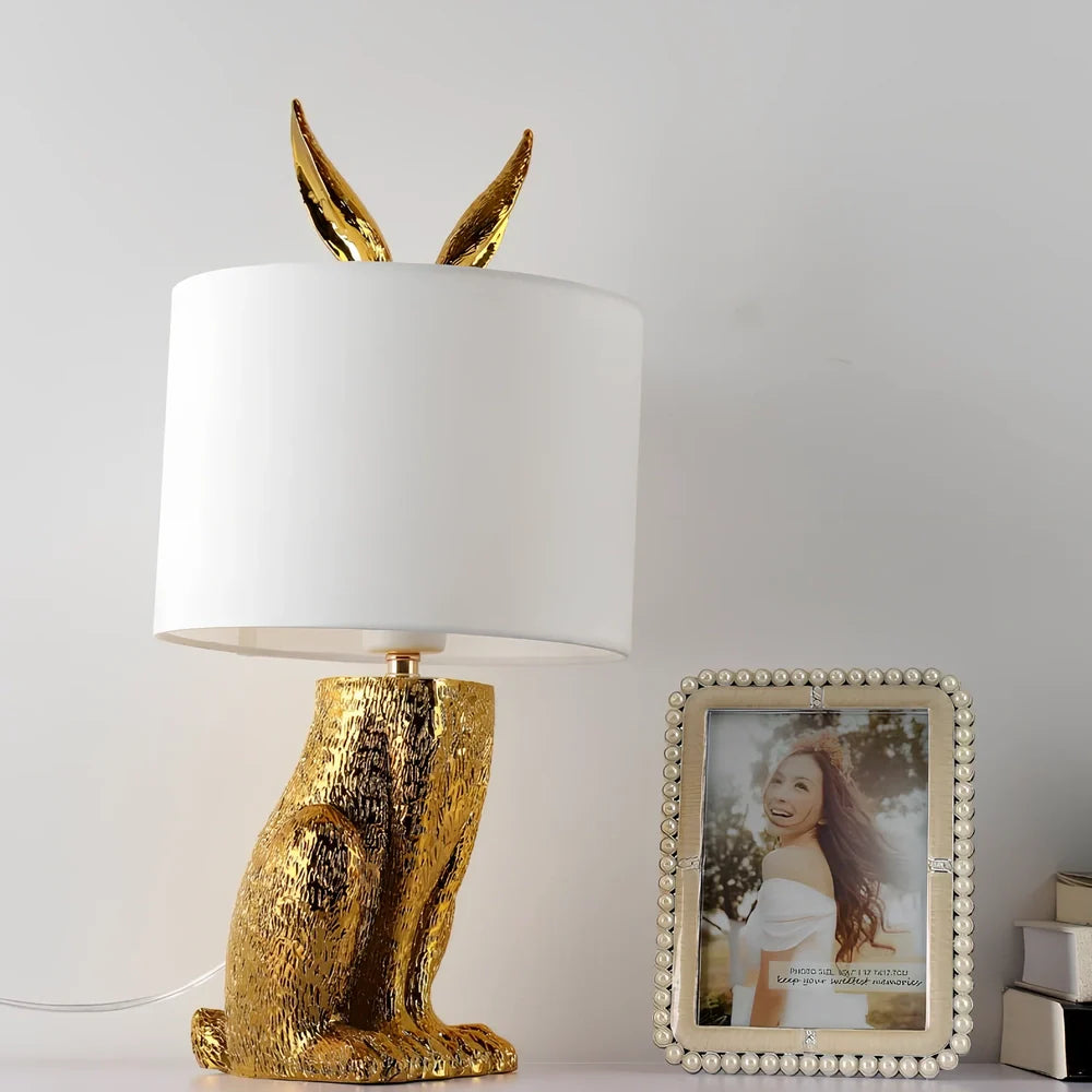 White rabbit table lamp with metal base and resin details, 24cm wide by 49cm high