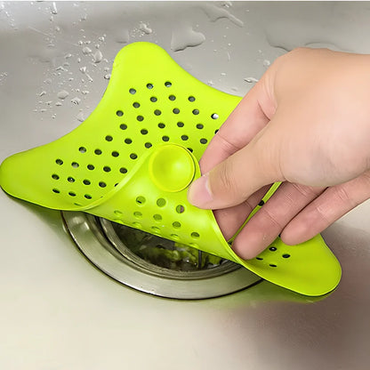 Three starfish-shaped sink drain filters in white, blue and green colours showing suction cups on bottom