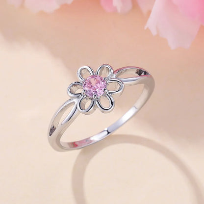 Women's hollow flower design fashion ring in electroplated copper with a platinum pink diamond finish.