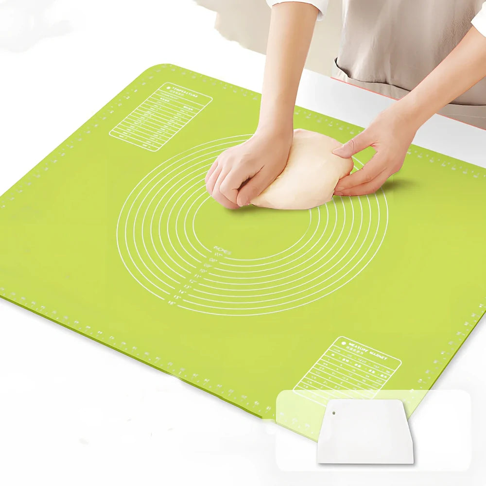 Green antibacterial silicone kneading mat with noodle cutter and rolling pin on kitchen counter