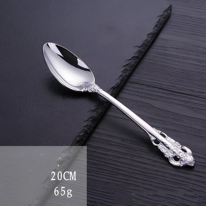 Four-piece stainless steel cutlery set showing main knife, fork, spoon, and teaspoon with mirror finish