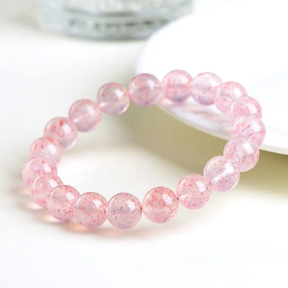 Stretch bracelet with round faceted strawberry quartz crystal beads in a white water colour.