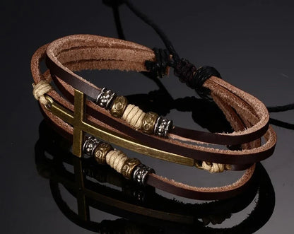 A handcrafted leather bracelet featuring a cross design, perfect for adding a touch of rustic style to any outfit.