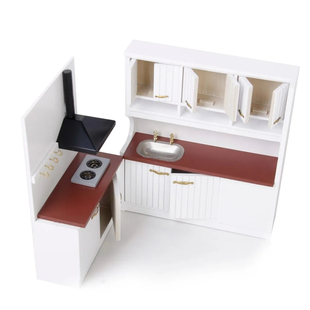 White European-style dollhouse kitchen cabinets with working doors and metal handles on a wooden surface.