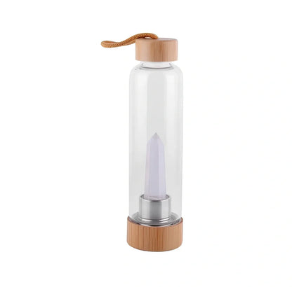 Crystal infused glass water bottle with bamboo lid showing mineral crystal inside 25cm tall container