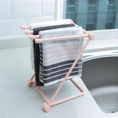 Foldable plastic dishcloth shelf organiser in Nordic style mounted on a kitchen wall