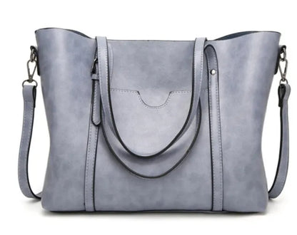 Retro messenger bag showing 31cm length, A4 magazine capacity, available in eight colours including wine red and light blue