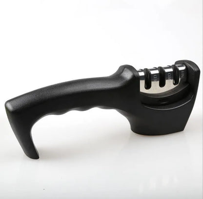Black manual knife sharpener with three tungsten wire slots and rubber feet on base