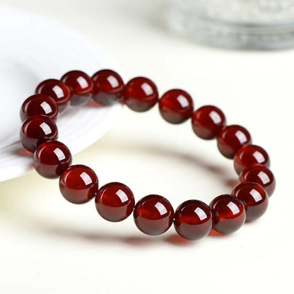 Natural orange red garnet crystal ball bracelet with traditional Ruyi design elements and adjustable bead sizing