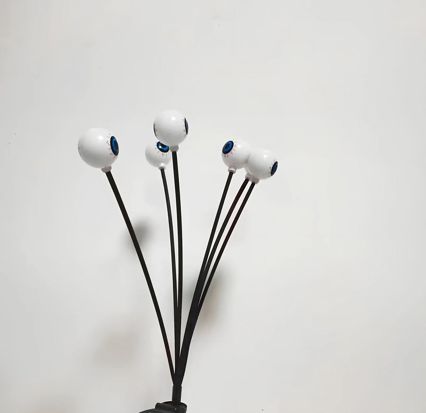 Solar-powered Halloween string lights with detailed eyeball design for outdoor garden decoration