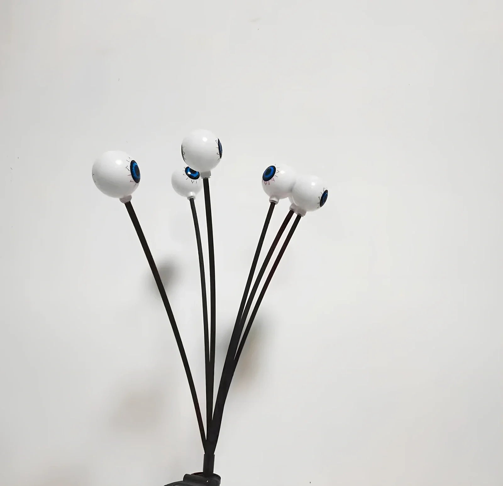 Solar-powered Halloween string lights with detailed eyeball design for outdoor garden decoration