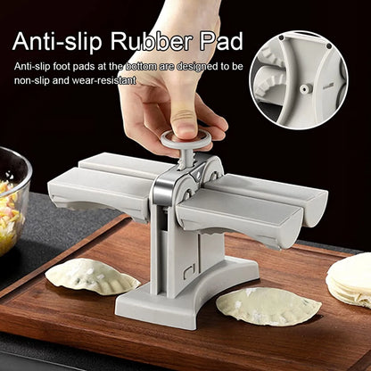 White double-head manual dumpling maker press on a kitchen counter