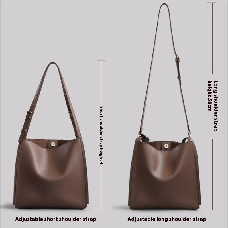 Brown genuine leather women's bucket bag with double shoulder straps showing organisational compartments