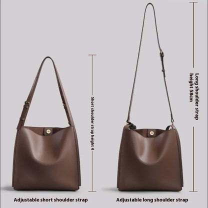 Brown genuine leather women's bucket bag with double shoulder straps showing organisational compartments