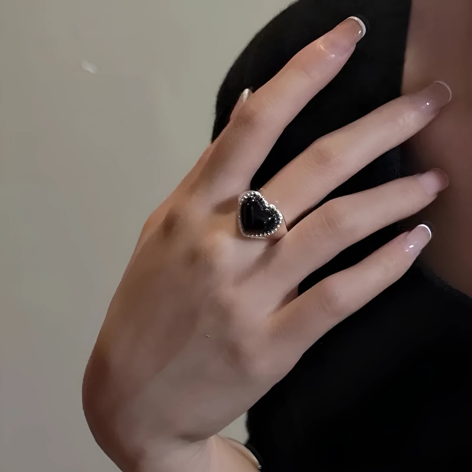 S925 sterling silver ring with a polished black heart-shaped agate stone on an adjustable open band.