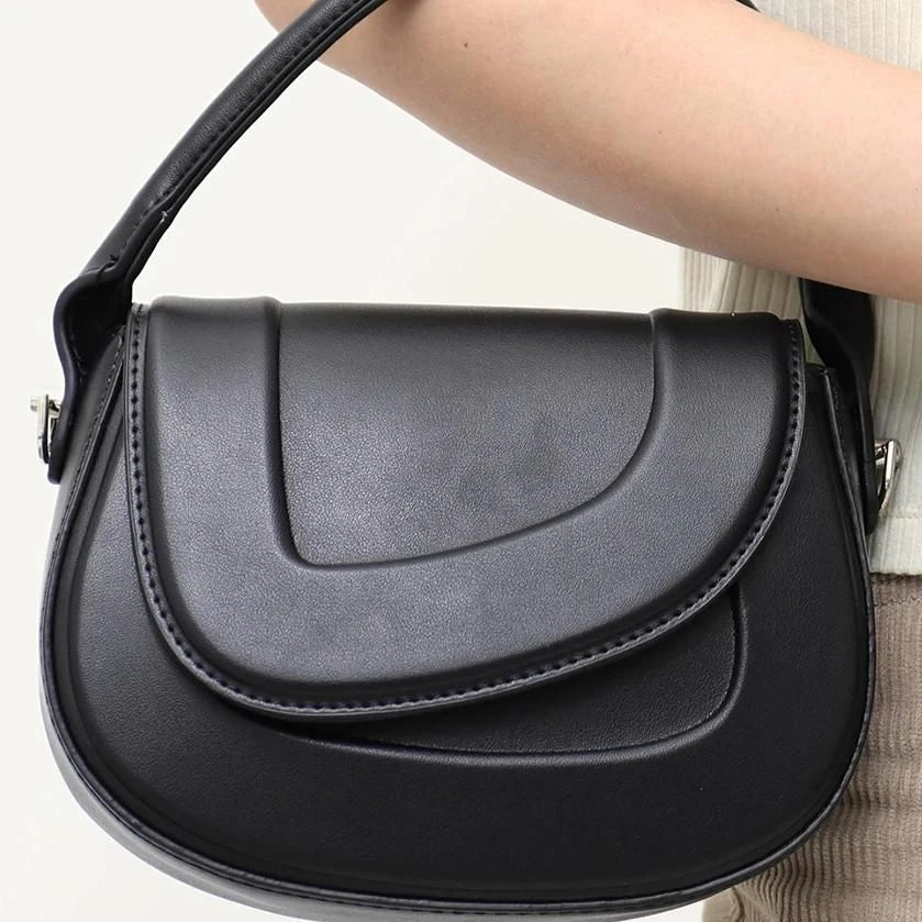 Elegant minimalist beige saddle-shaped shoulder bag with adjustable straps