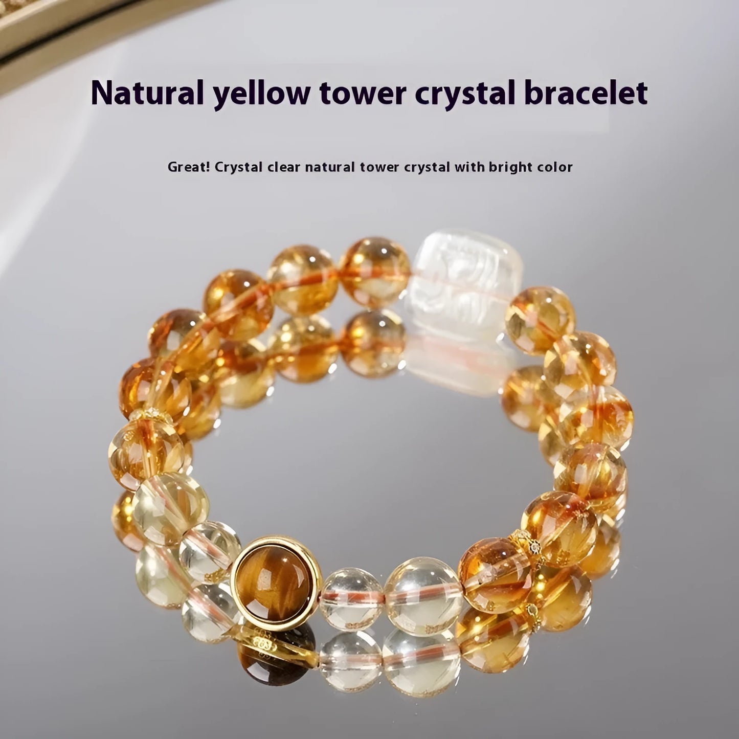 Close-up of a women's carved citrine bracelet with geometric patterns on 10mm crystal beads.