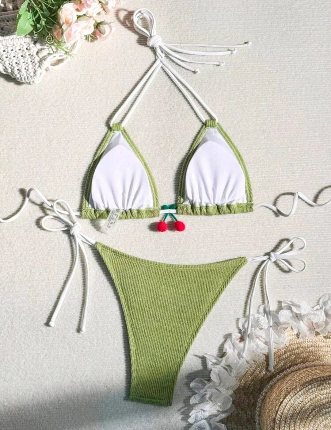 Solid colour briefs-style bikini swimsuit on a hanger, showing the top and pants.