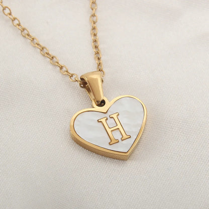 Gold-plated clavicle necklace with a white shell heart pendant, personalised with a letter from A to Z.