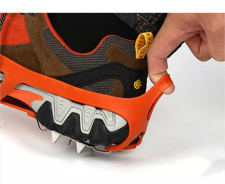 Reinforced large-tooth non-slip shoes in black and orange for superior traction on slippery surfaces