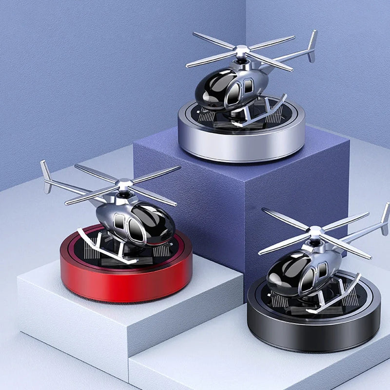 Solar-powered helicopter car air freshener with rotating propeller that diffuses cologne fragrance using metal perfume seat weighing 180g for continuous air freshening