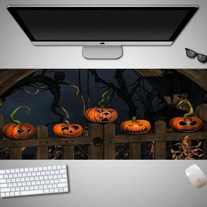 Halloween-themed oversized cloth mouse pad with non-slip rubber base on a wooden desk.