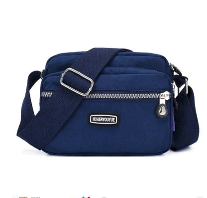 Compact nylon messenger bag in various colors with multiple compartments