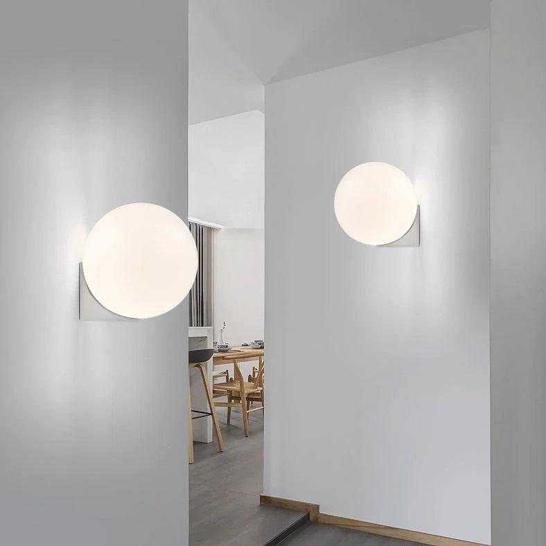 Nordic minimalist wall lamp with adjustable double heads in black finish mounted on white wall