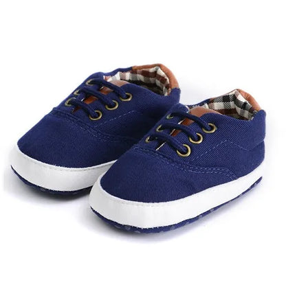 Baby canvas shoes in solid colour with soft bottom and front strap, sizes 11cm to 13cm
