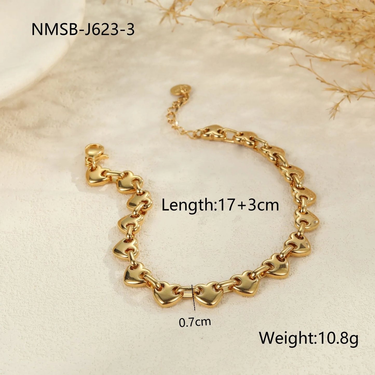 Women's hollow heart bracelet in stainless steel with 18K gold plating, shown in colour block, gold, and steel finishes