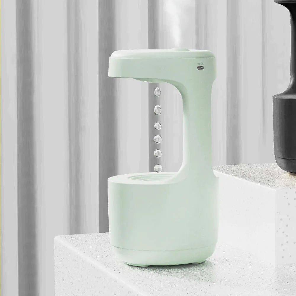 White columnar anti-gravity humidifier with LED clock display on a wooden desk