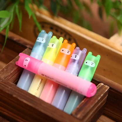 Set of six slanted plastic highlighter pens showing six different fluorescent ink colours.