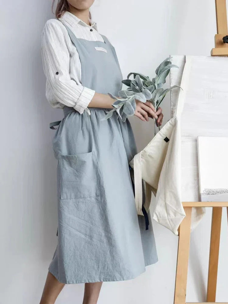 Sleeveless cotton kitchen apron in blue colour showing front coverage and adjustable neck strap