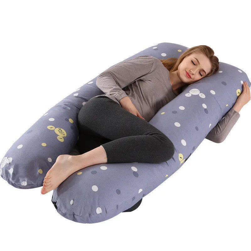 Large U-shaped pregnancy support pillow with removable cover and abdominal support belt.