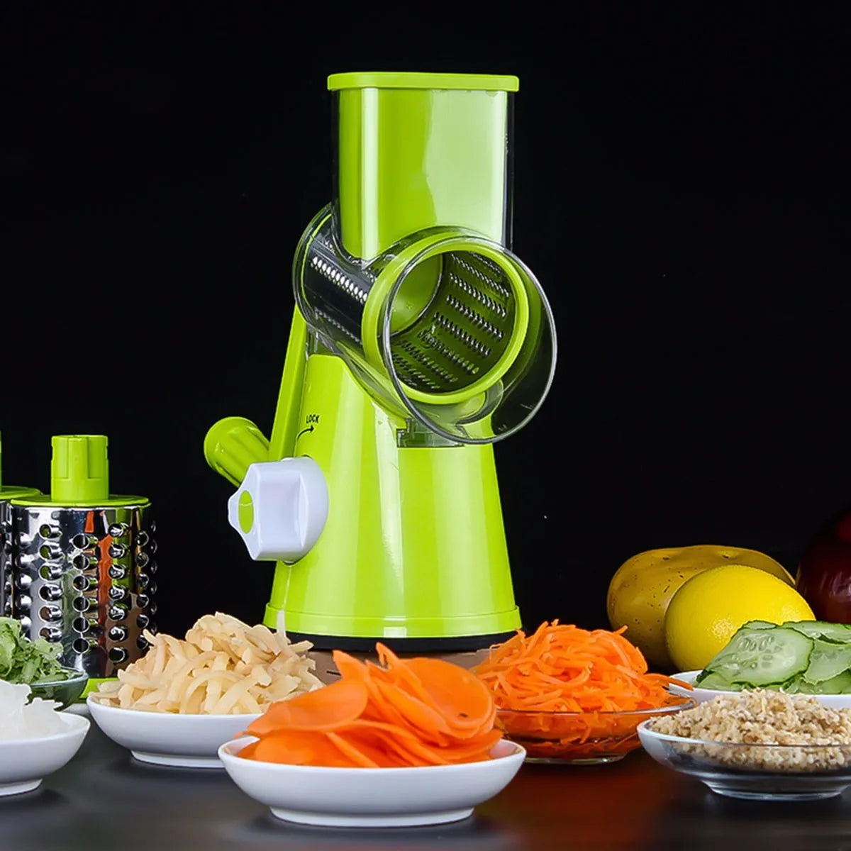 Round mandoline vegetable slicer with three stainless steel blades and a rubber suction base, in blue green colour.