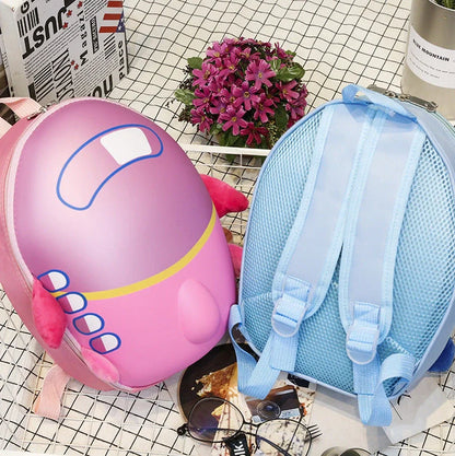 Blue aircraft-shaped children's hard shell backpack with cartoon graphics and adjustable shoulder straps