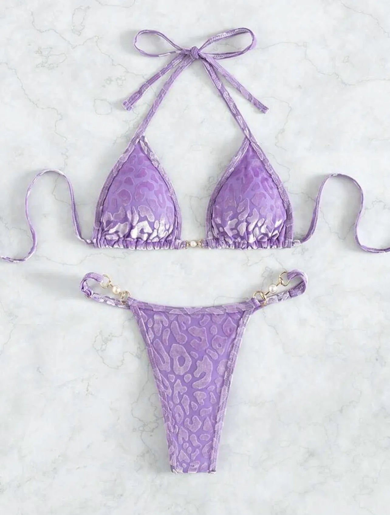 Women's blue leopard print T-shaped bikini set for swimming on a mannequin.