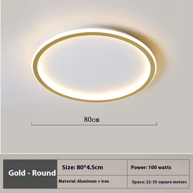 Minimalist circular ceiling lamp in gold finish mounted on a white ceiling