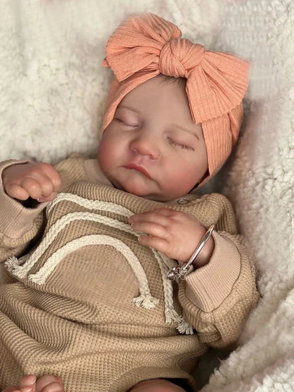 18-inch reborn doll with cloth body and hand-painted vinyl head wearing pink romper
