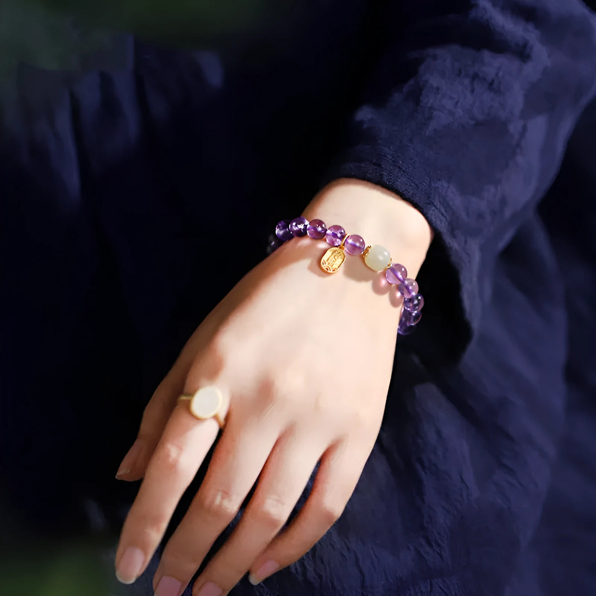 Purple amethyst crystal bead bracelet with geometric shape on an adjustable chain.