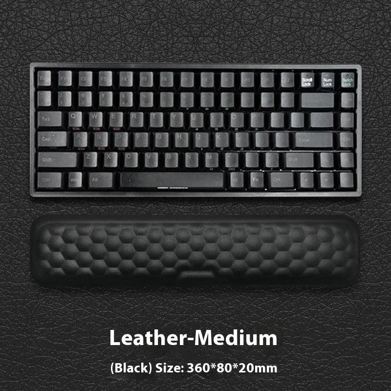 Black and grey memory foam mouse wrist rests with cloth and leather-style covers on a desk.