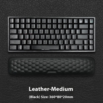 Black and grey memory foam mouse wrist rests with cloth and leather-style covers on a desk.