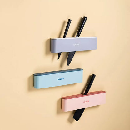 Wall-mounted kitchen knife holder in grey, pink, or light blue, semi-open design for better air circulation