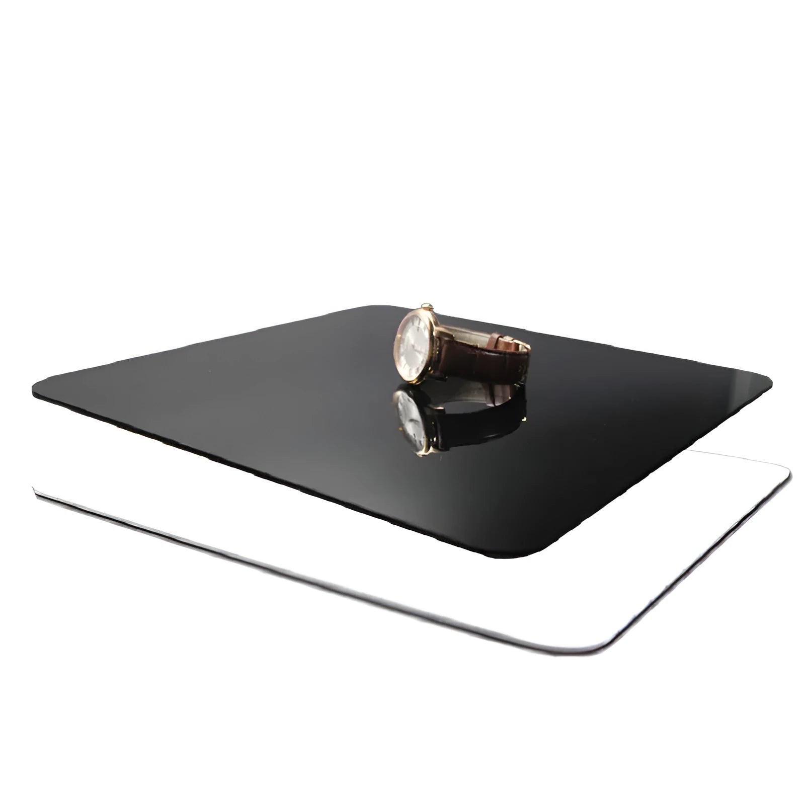 Square black and white acrylic reflection boards for product photography on a table