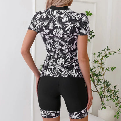 Women's floral print swimsuit with zipper front and matching swim shorts in black