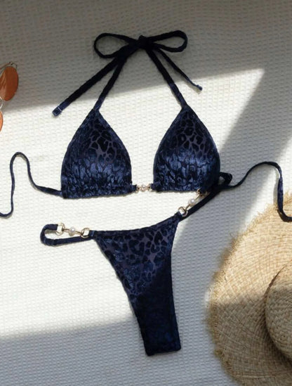 Women's blue leopard print T-shaped bikini set for swimming on a mannequin.