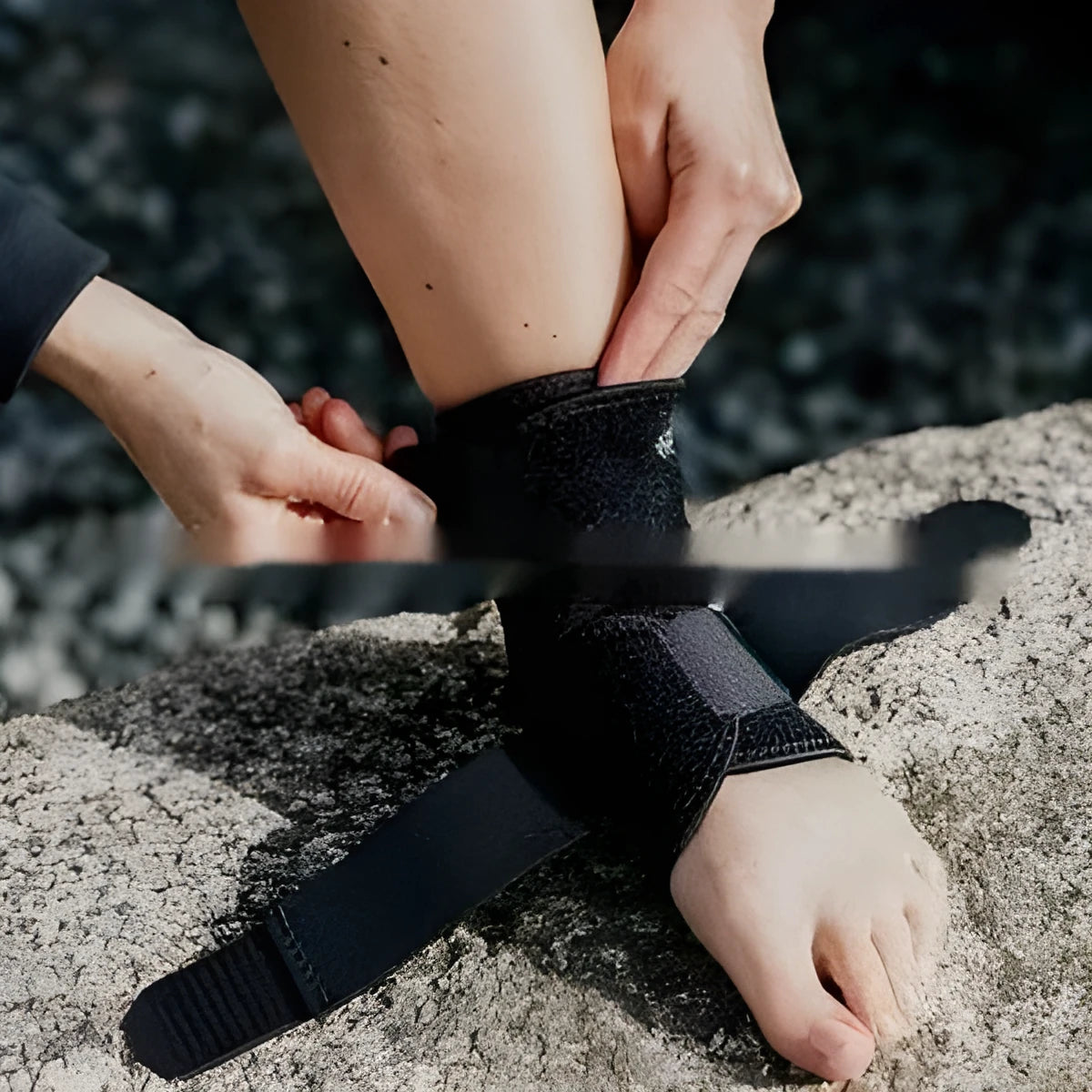 A single black sports ankle support laid flat, designed for injury protection during various athletic activities.