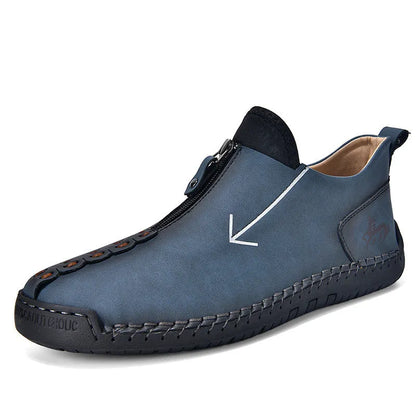 Men's black leather boots with front zipper, hand-stitched detailing, and rubber sole on a neutral background