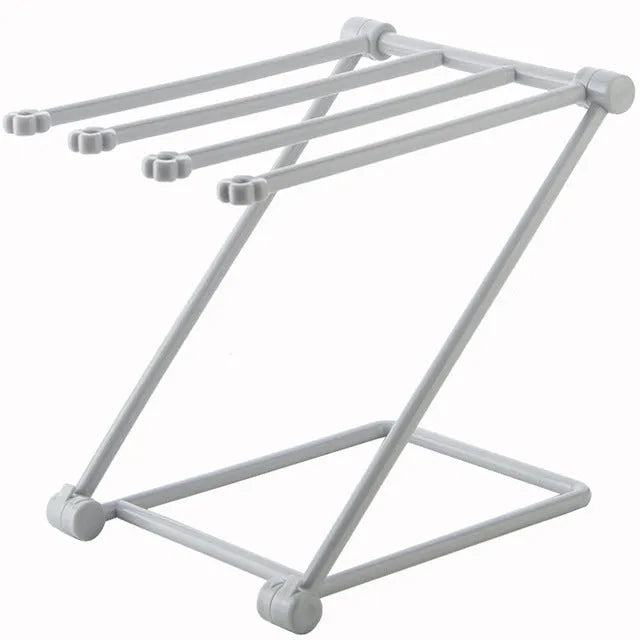 Foldable plastic dishcloth shelf organiser in Nordic style mounted on a kitchen wall